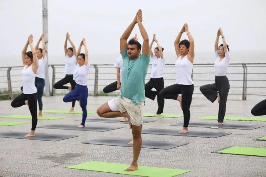student doing yoga pose in online yoga ttc session